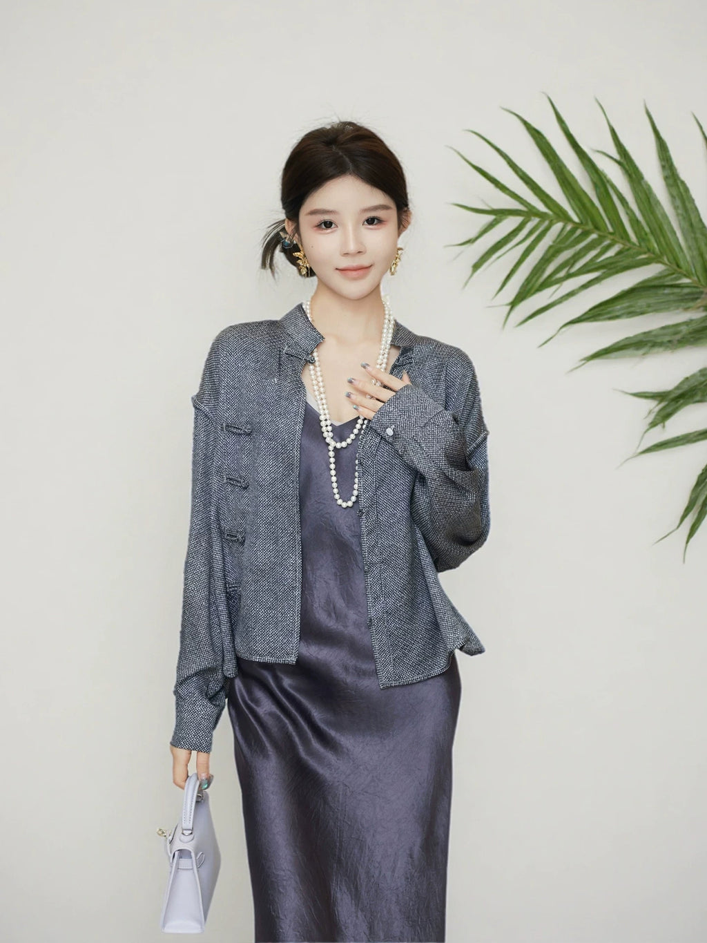 Model wearing a grey Chinese-inspired mulberry silk jacket with a mandarin collar