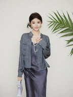 Model wearing a grey Chinese-inspired mulberry silk jacket with a mandarin collar