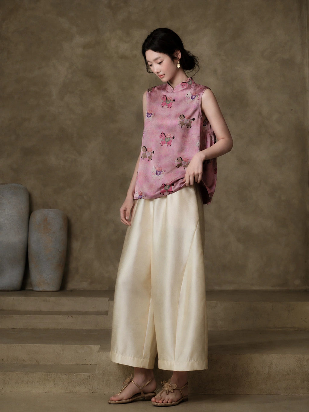 Pink horse-motif jacquard vest styled with flowing ivory trousers for a modern New Chinese outfit