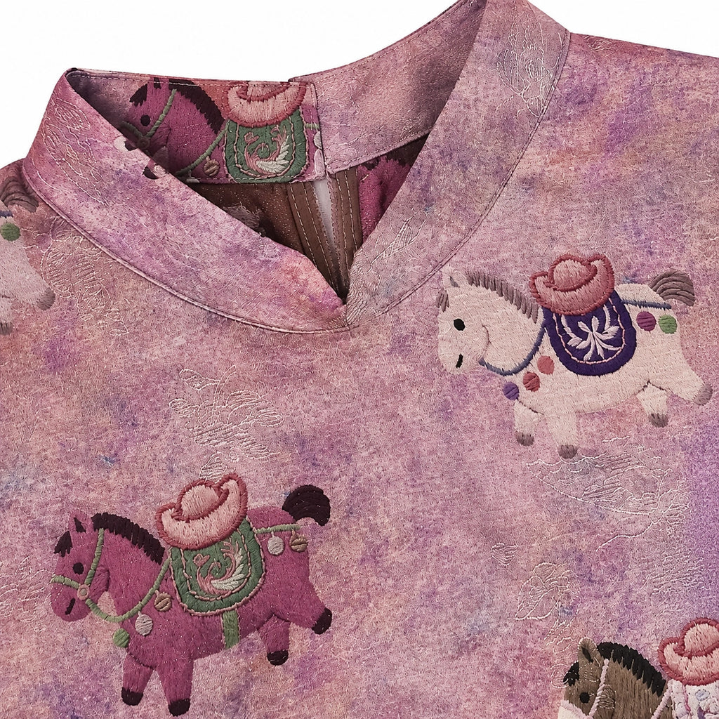 Close-up of the Mandarin collar, lustrous jacquard texture and multicolored horse motifs