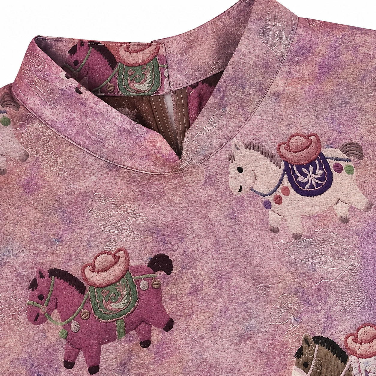 Close-up of the Mandarin collar, lustrous jacquard texture and multicolored horse motifs