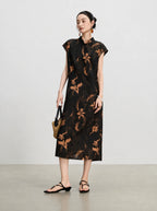 Three-quarter view of a sleeveless black Hua Luo silk midi dress with copper floral print