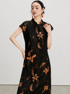 Upper-body view of the black Hua Luo silk dress with copper floral motifs and stand collar