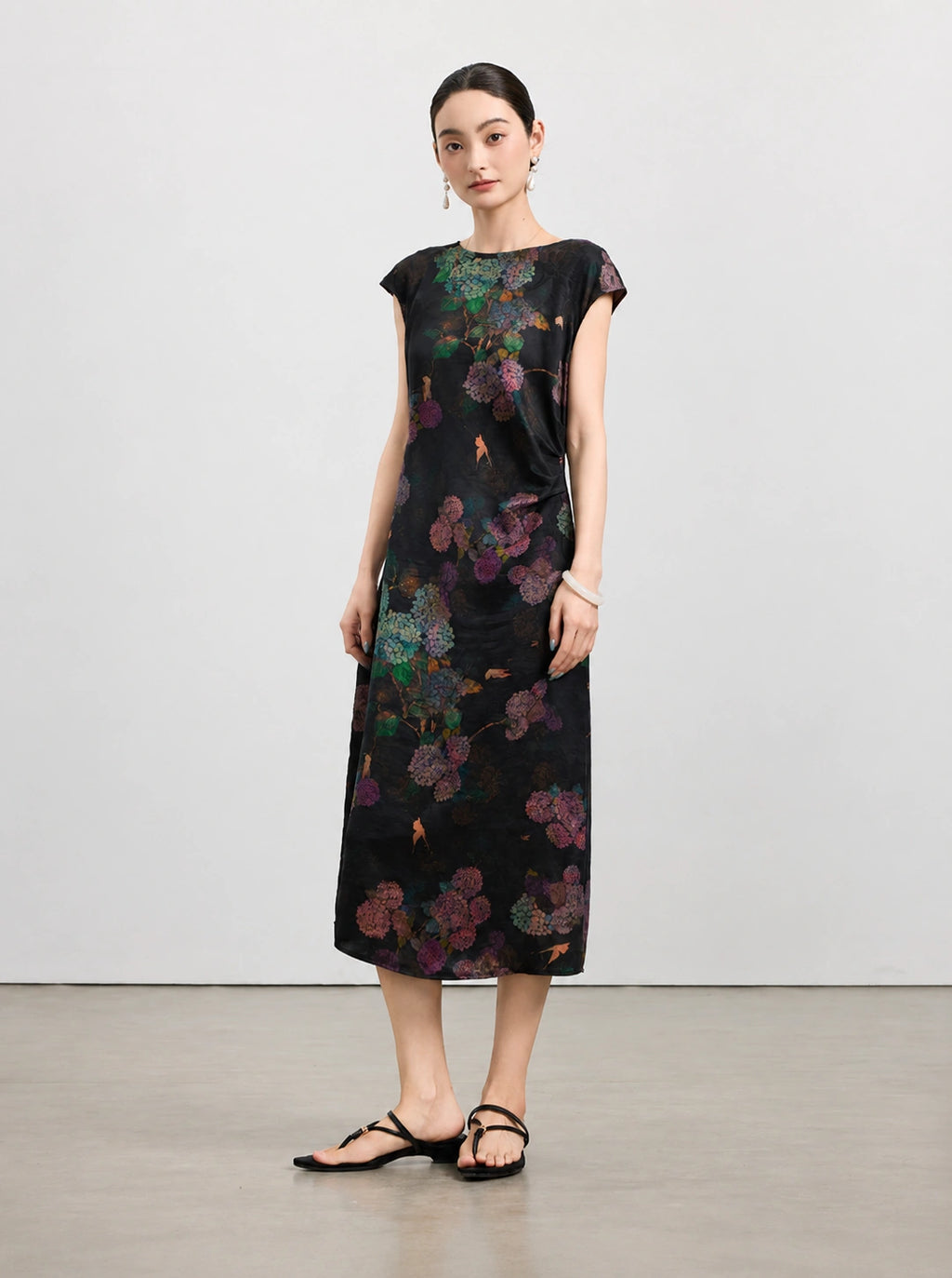 Full-length view of a black New Chinese silk dress with purple and teal hydrangea print.