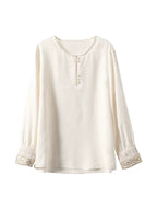 Gambiered Silk warm-ivory satin blouse with tonal butterfly jacquard, long sleeves and embellished cuffs.