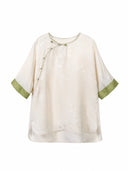 Front view of an ivory silk top with an asymmetrical Chinese-style closure