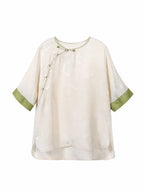 Front view of an ivory silk top with an asymmetrical Chinese-style closure