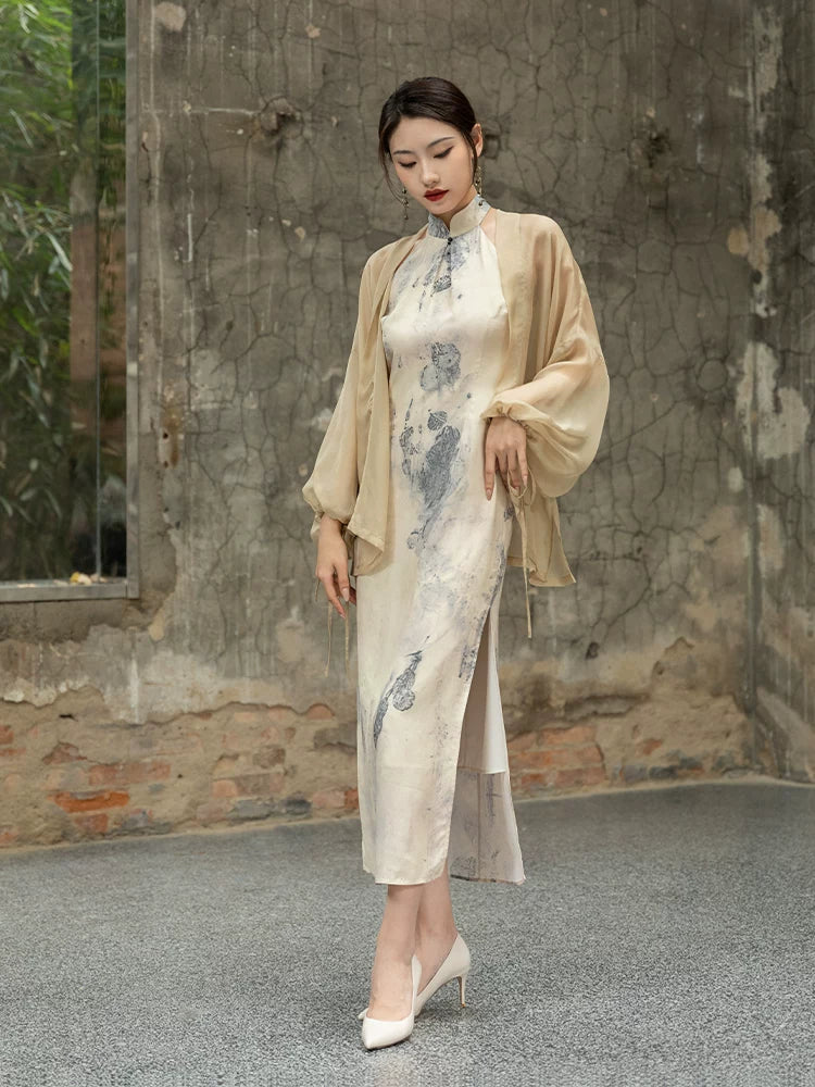 Front view of an ivory ink print silk cheongsam paired with a flowing silk shawl.