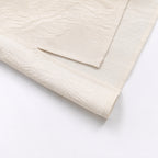 Close-up of the textured ivory silk fabric and refined woven pattern
