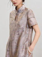 Upper-body view of the luminous scenic jacquard, stand collar and ornamental knot closure