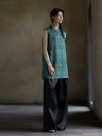 Full-length view of an emerald jacquard Gambiered Silk sleeveless tunic in relaxed fit.