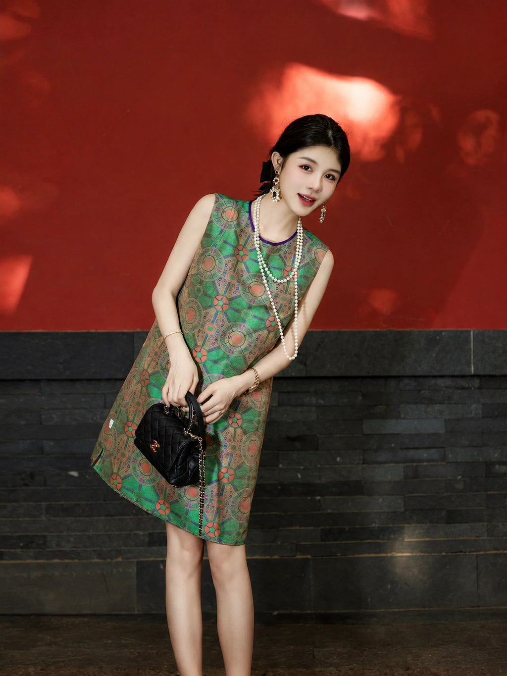 Lifestyle view of a model wearing a jade green modern Chinese Shu brocade silk dress.