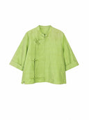 Front view of a jade green mulberry silk top with a stand collar and Chinese-inspired button closures