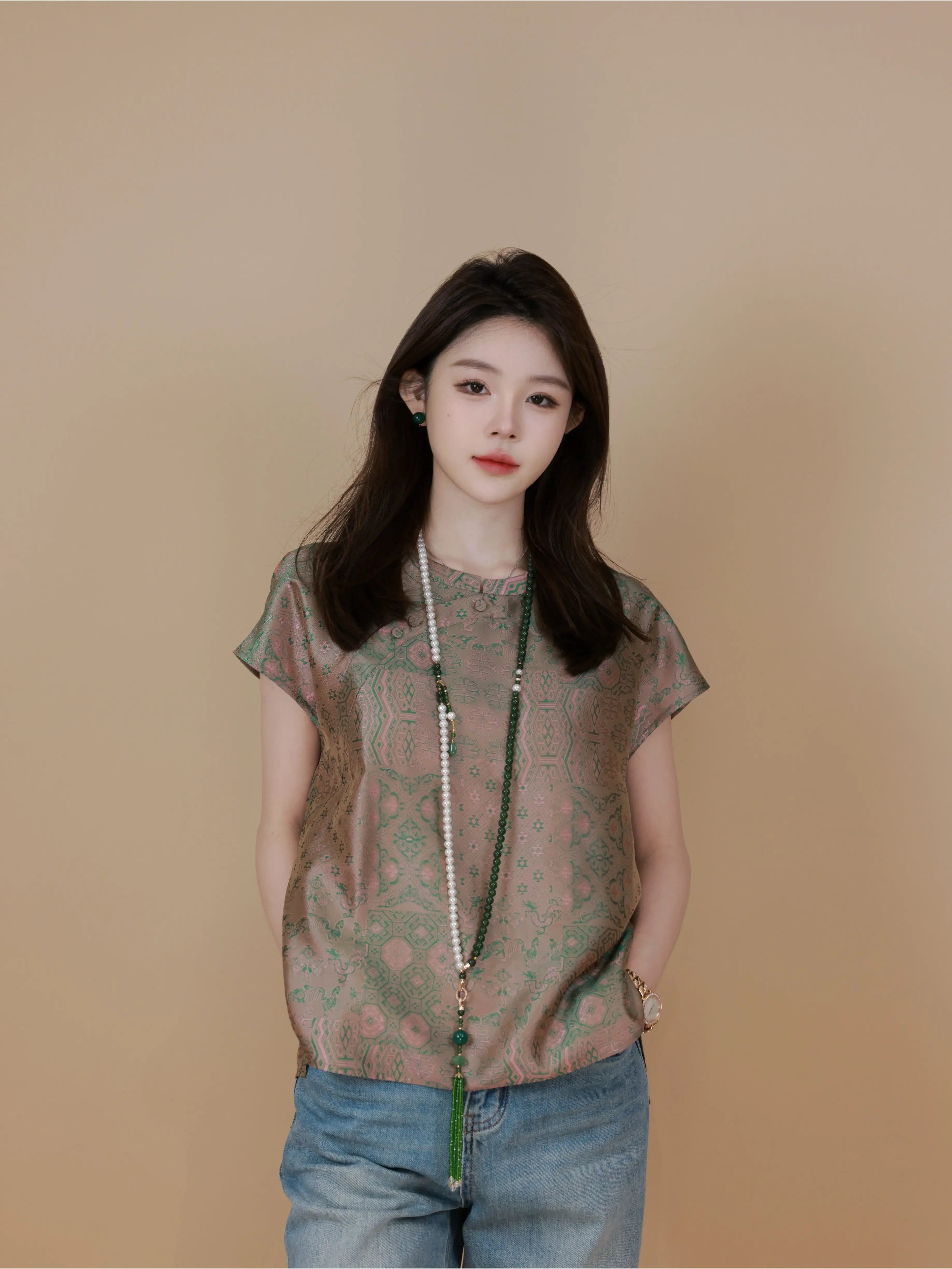 Model wearing a jade green Chinese-inspired mulberry silk top with short straight sleeves