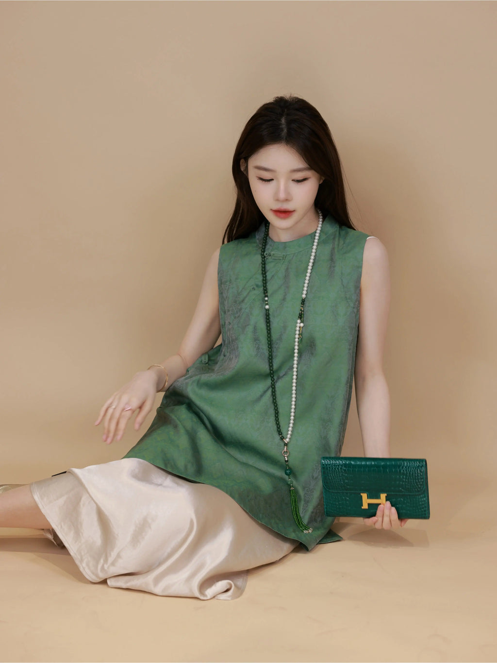 Model wearing a jade green Chinese-inspired mulberry silk sleeveless top