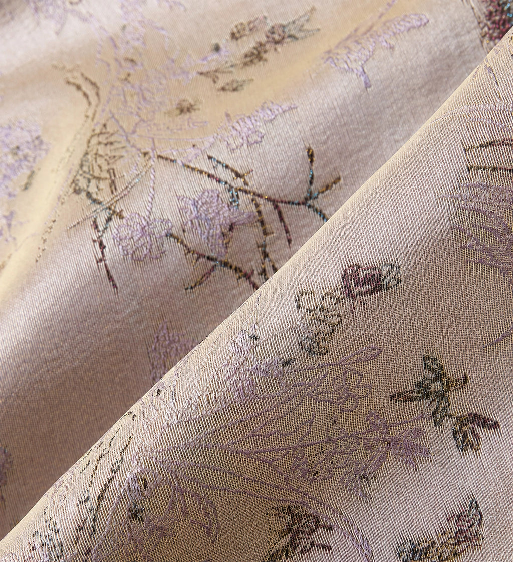 Close-up of the shimmering silk jacquard woven with lavender Jiangnan scenery and fine motifs