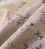 Close-up of the shimmering silk jacquard woven with lavender Jiangnan scenery and fine motifs