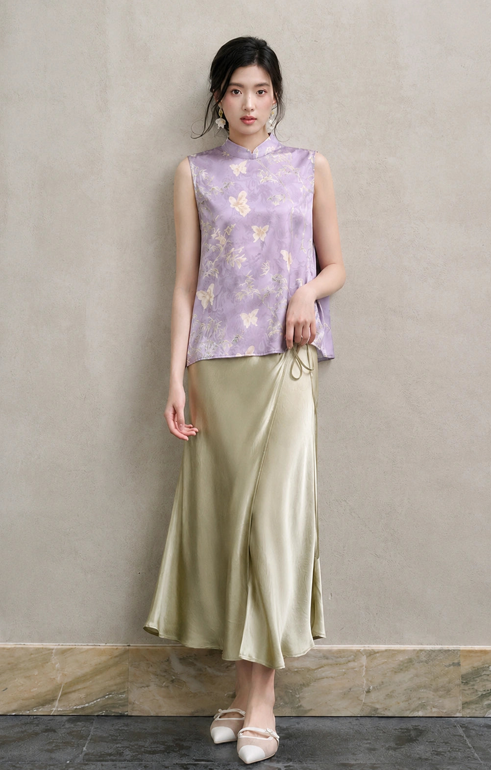 Full-length styling view of the lavender butterfly-print vest with wide-leg trousers