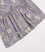 Close-up of the softly gathered back panel and bamboo-butterfly pattern