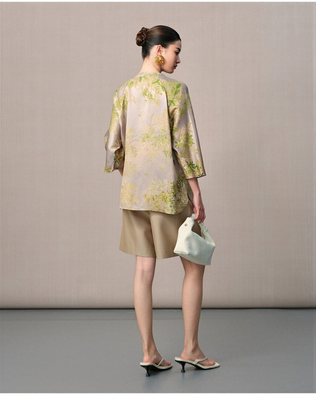 Back view of the taupe mulberry silk blouse with green botanical print and three-quarter sleeves