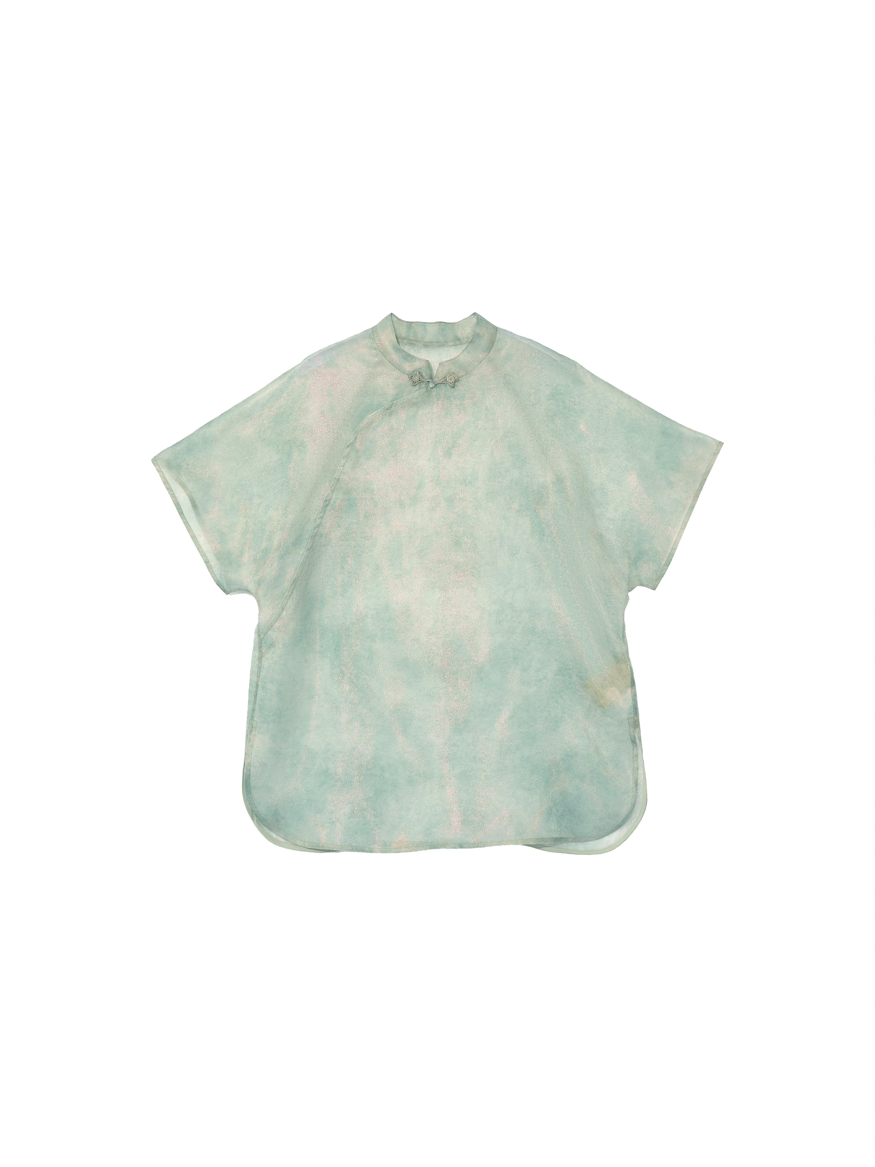 Flat lay of the light celadon silk cheongsam top featuring a Mandarin collar, frog closure and relaxed silhouette.