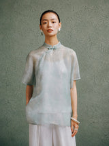 Light celadon silk cheongsam top for women by Gambiered Silk, front model view with modern Mandarin collar and relaxed fit.