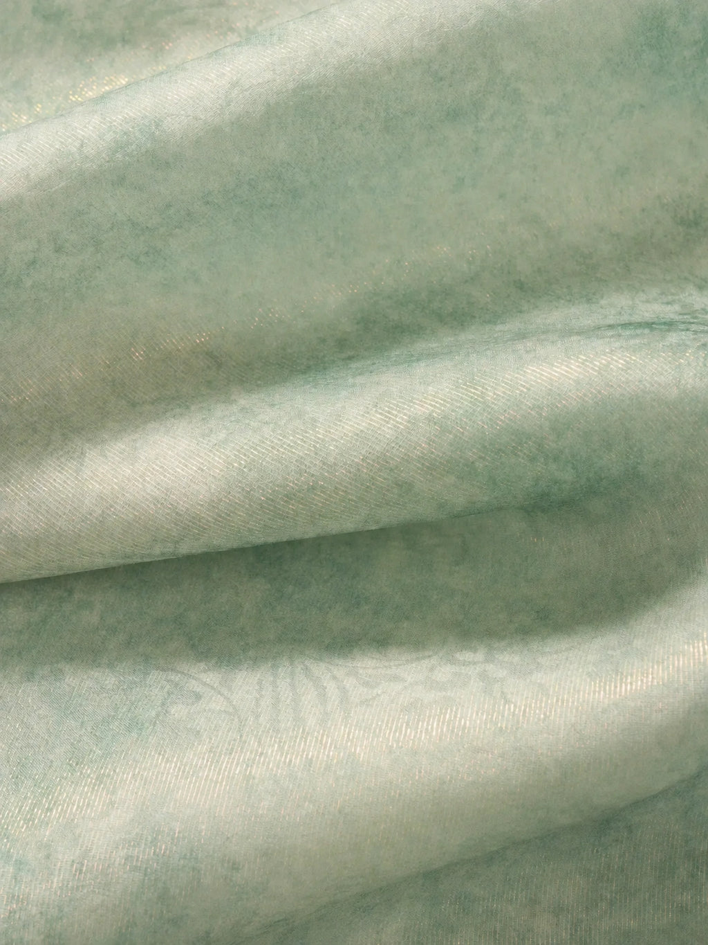 Close-up of the lightweight mulberry silk fabric with subtle sheen and soft texture used in the light celadon silk cheongsam top.