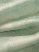 Close-up of the lightweight mulberry silk fabric with subtle sheen and soft texture used in the light celadon silk cheongsam top.