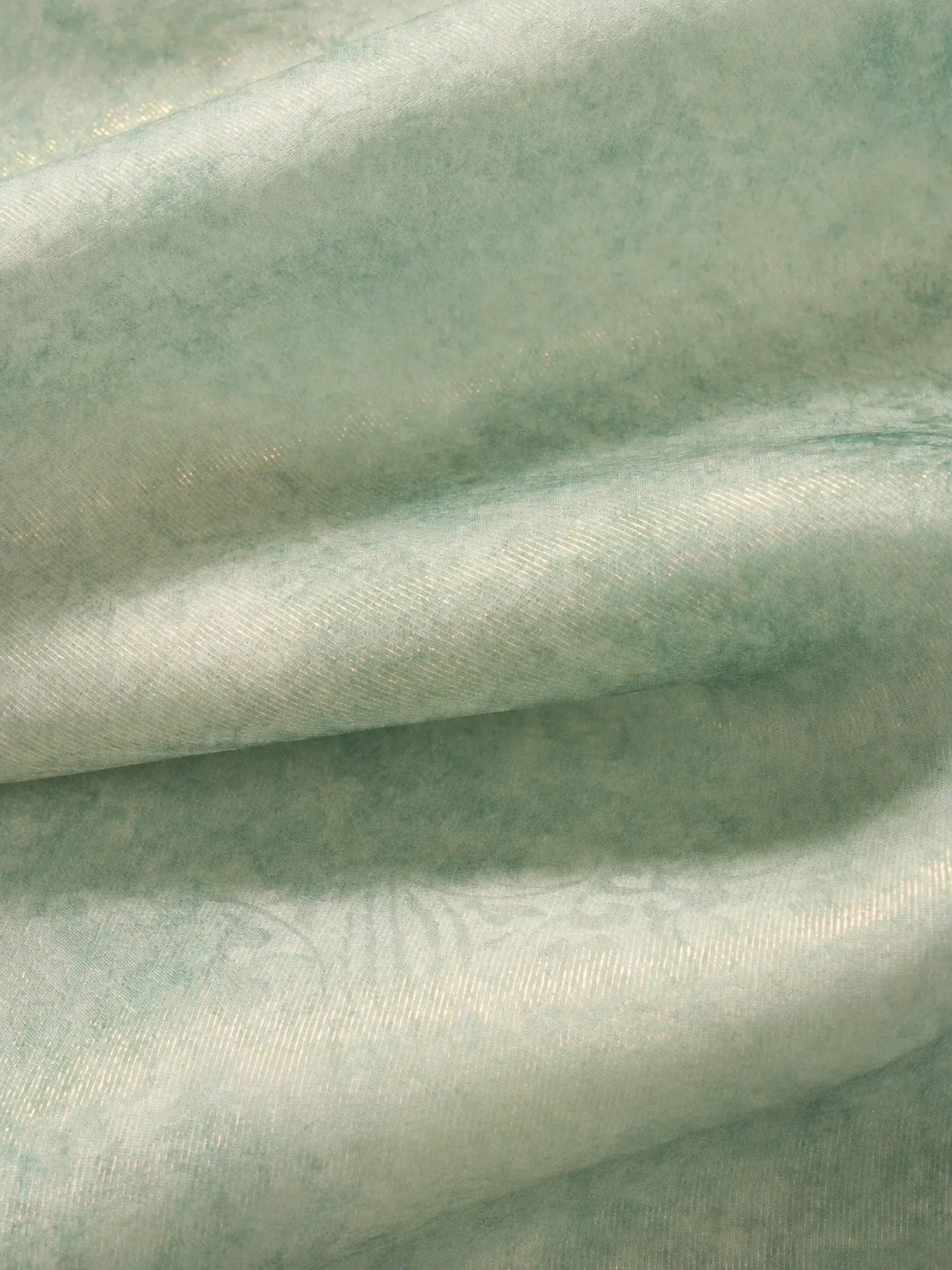 Close-up of the lightweight mulberry silk fabric with subtle sheen and soft texture used in the light celadon silk cheongsam top.
