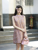Front model view of a lilac-pink luminous brocade silk dress with golden floral motifs.