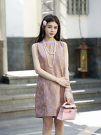 Front model view of a lilac-pink luminous brocade silk dress with golden floral motifs.