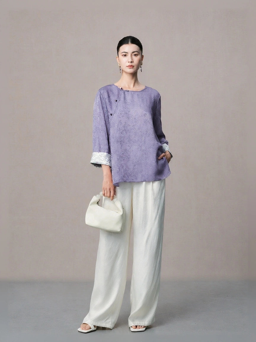 Elegant lilac mulberry silk blouse paired with white wide-leg trousers.