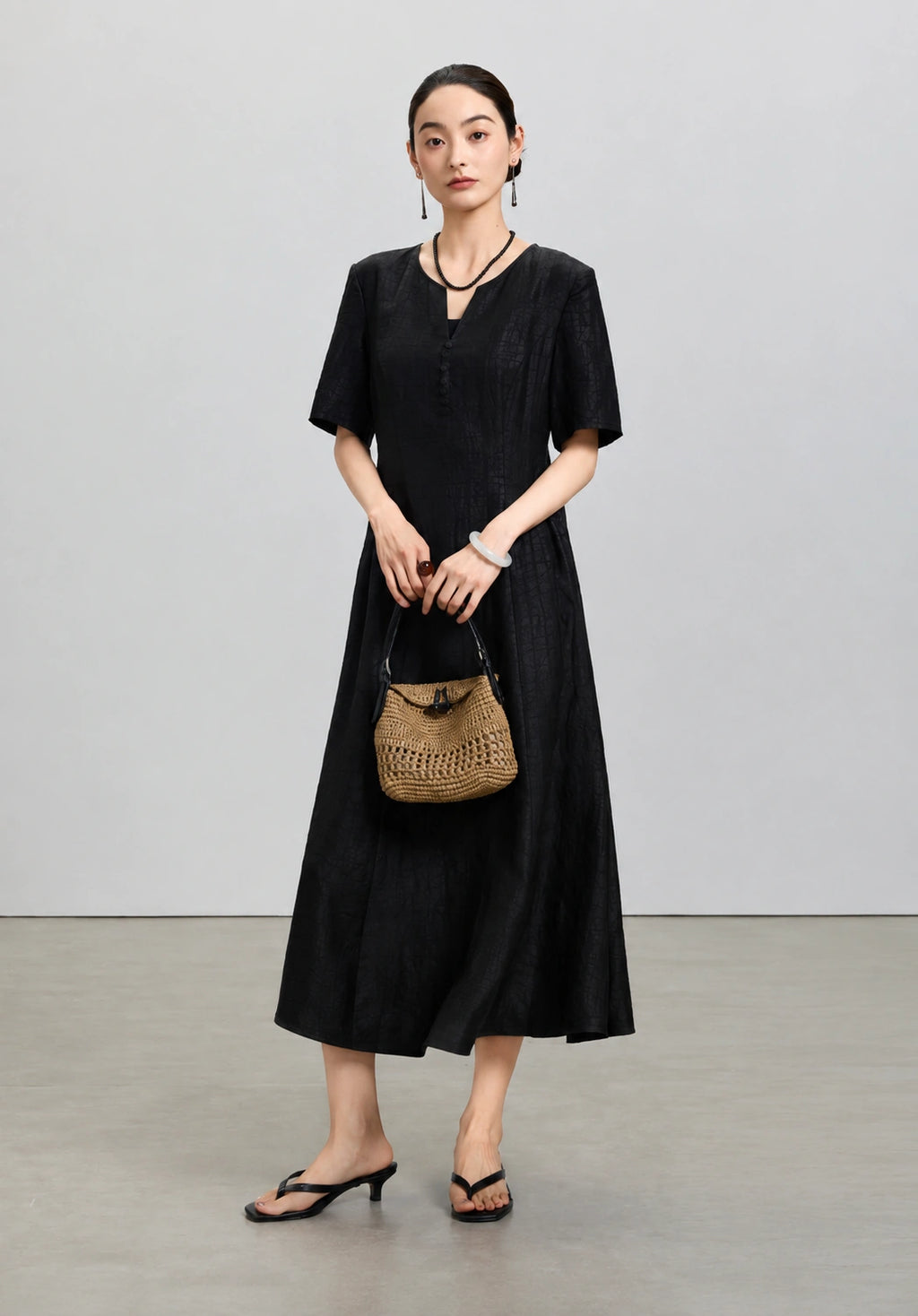 Front styled view of the black mulberry silk midi dress from the Little Black Dress 2.0 collection