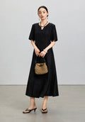 Front styled view of the black mulberry silk midi dress from the Little Black Dress 2.0 collection