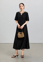 Front styled view of the black mulberry silk midi dress from the Little Black Dress 2.0 collection