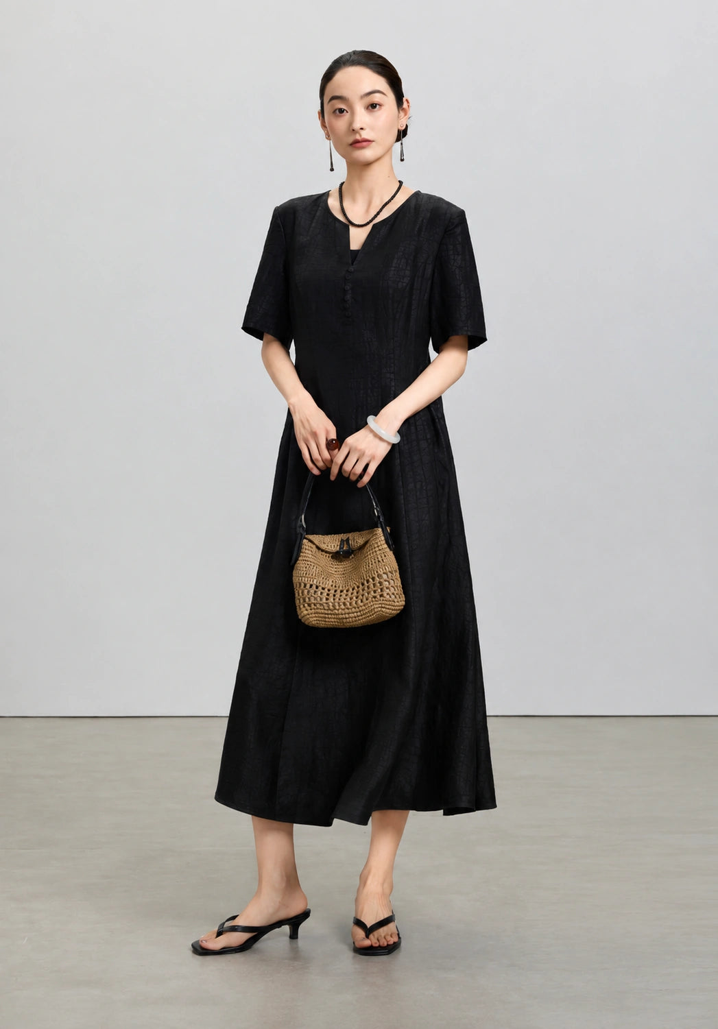 Front styled view of the black mulberry silk midi dress from the Little Black Dress 2.0 collection