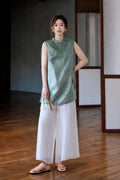 Front styled view showing the relaxed fit and deep side slits of the Song brocade vest