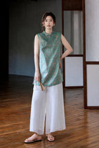 Front styled view showing the relaxed fit and deep side slits of the Song brocade vest