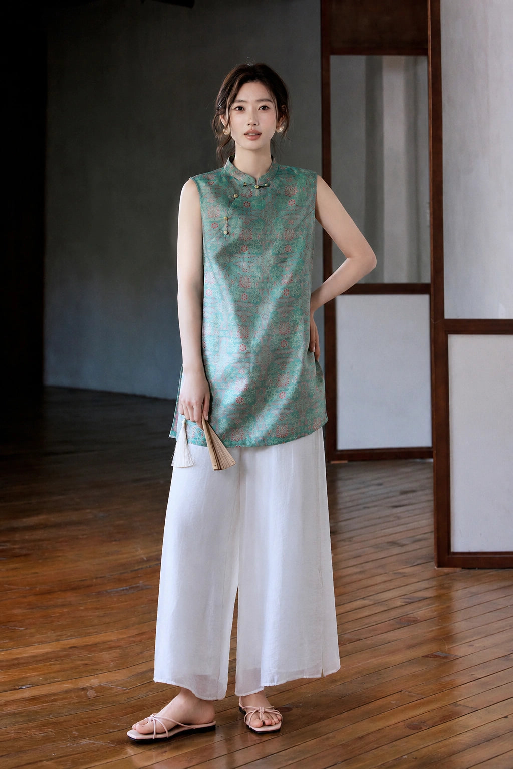 Front styled view showing the relaxed fit and deep side slits of the Song brocade vest