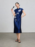 Full-length view of the navy sleeveless qipao with beaded magnolia embroidery