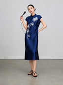 Full-length view of the navy sleeveless qipao with beaded magnolia embroidery
