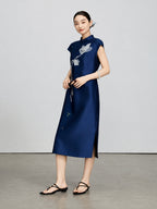 Model wearing a navy silk-wool qipao with white magnolia embroidery and a side slit