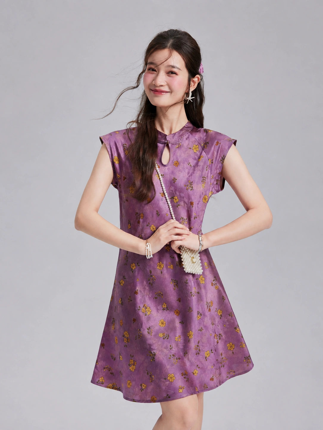 Front view of a Gambiered Silk floral dress with extended-shoulder sleeves and a keyhole neckline.