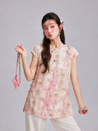 Gambiered Silk floral top with a Mandarin collar, keyhole neckline, button details and soft cap sleeves