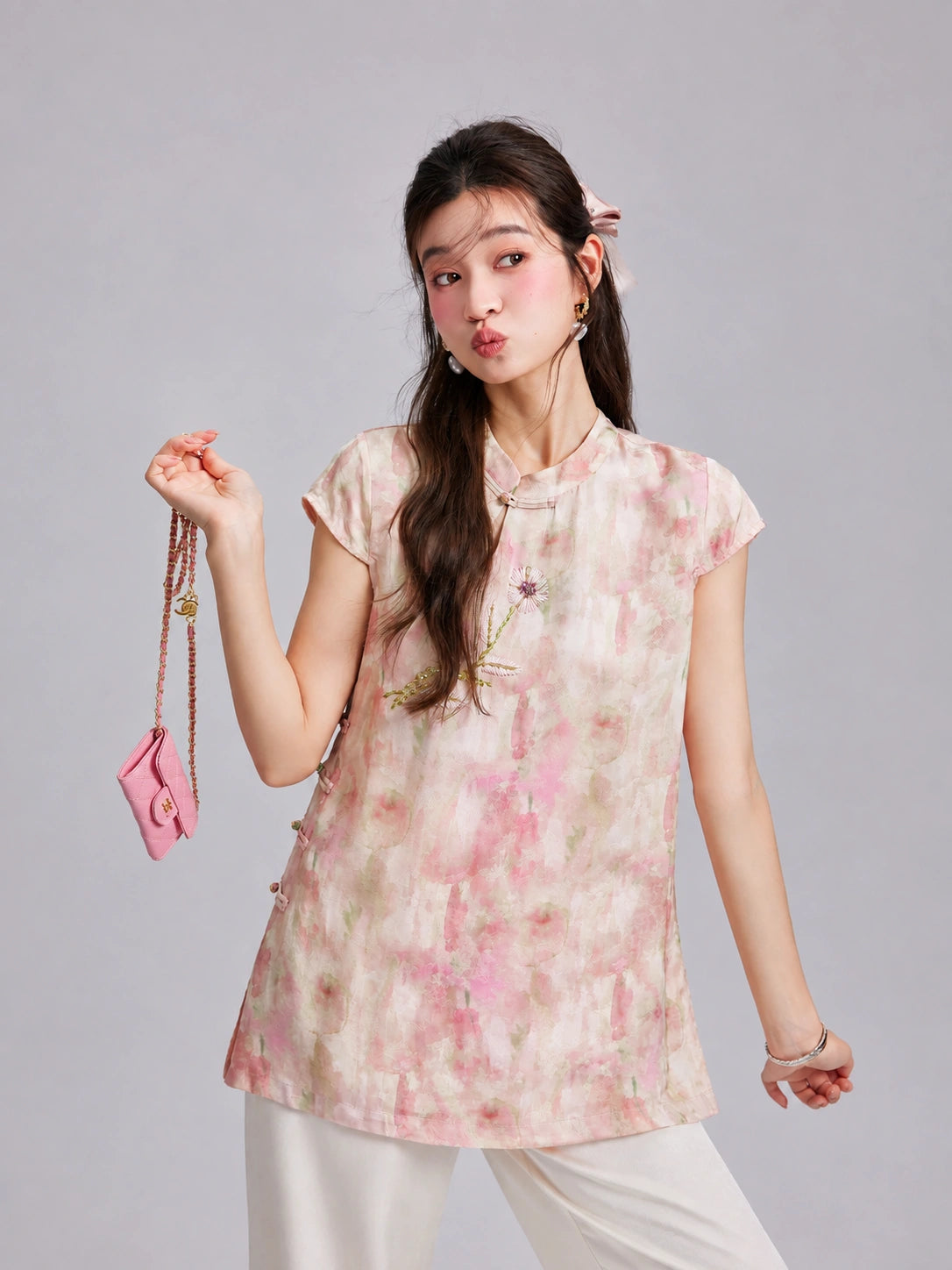 Gambiered Silk floral top with a Mandarin collar, keyhole neckline, button details and soft cap sleeves