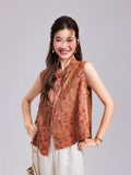 Model wearing a coral pink Gambiered Silk vest with a Mandarin collar, floral rabbit pattern and front opening