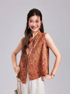 Model wearing a coral pink Gambiered Silk vest with a Mandarin collar, floral rabbit pattern and front opening