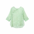 Front view of a mint green Chinese-inspired silk top with a subtle botanical texture