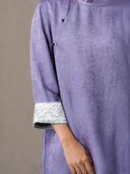 Close-up of lilac viscose and mulberry silk blouse cuff with traditional Chinese pattern.