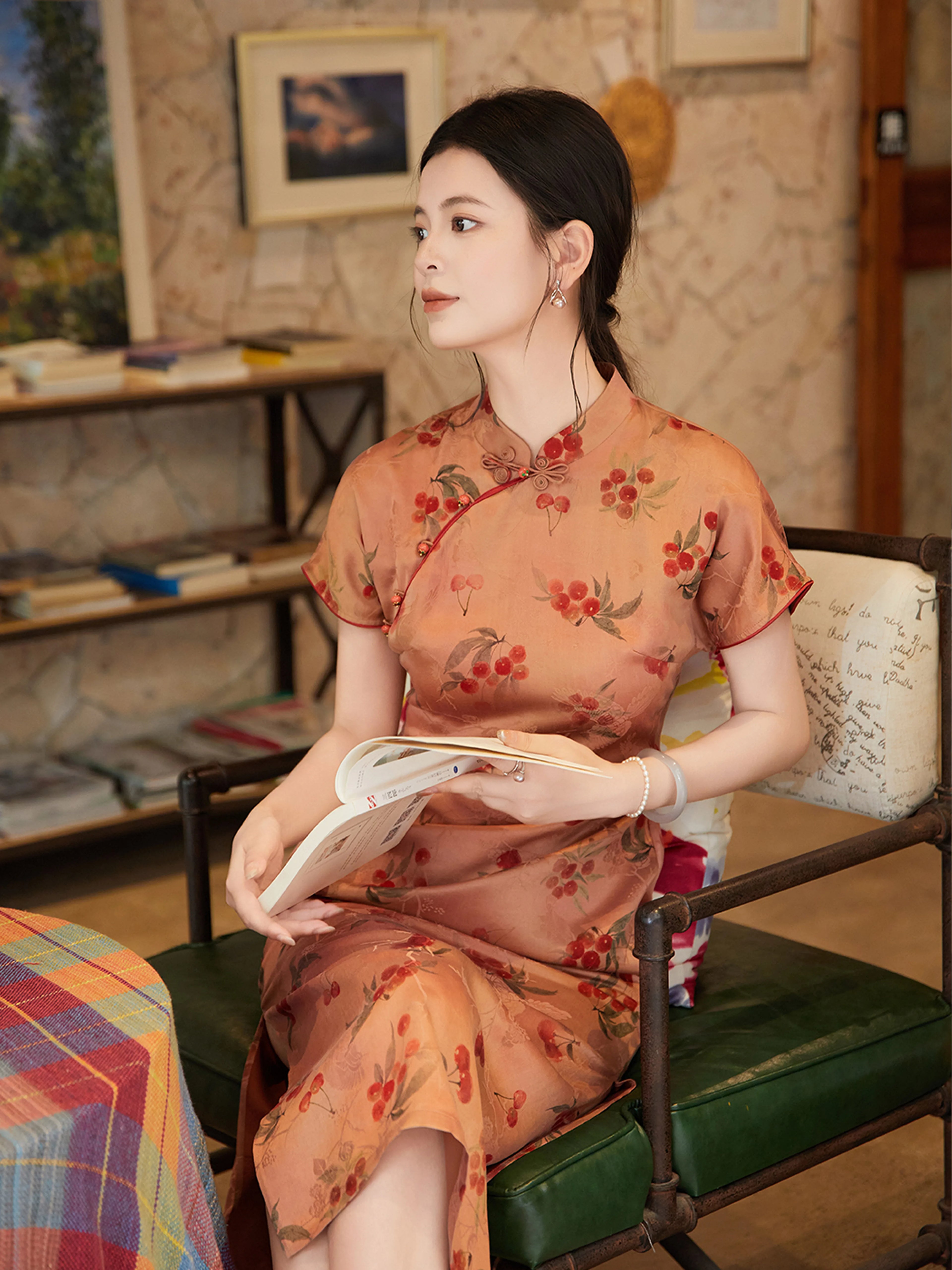 Woman wearing Gambiered Silk cherry print silk cheongsam indoors